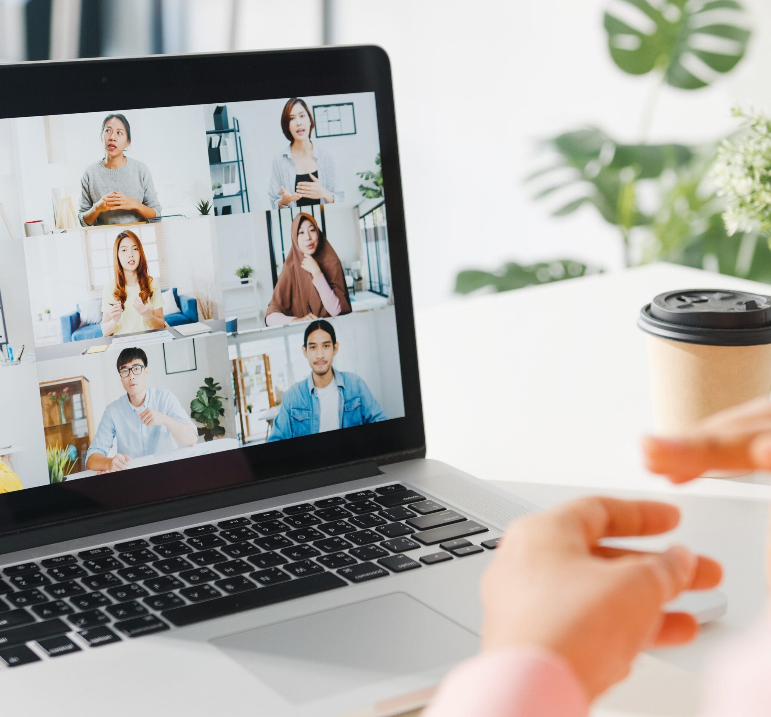 Young Asia businesswoman using laptop talk to colleague about plan in video call meeting while work from home at living room. Self-isolation, social distancing, quarantine for corona virus prevention.